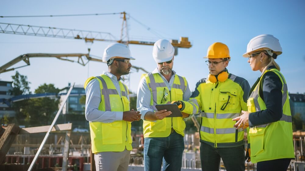 Construction professionals reviewing plans on site