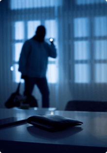 Intruder in a home at night with a flashlight