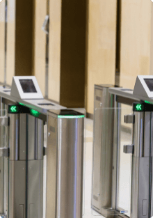 Modern security turnstile gates with green access indicators